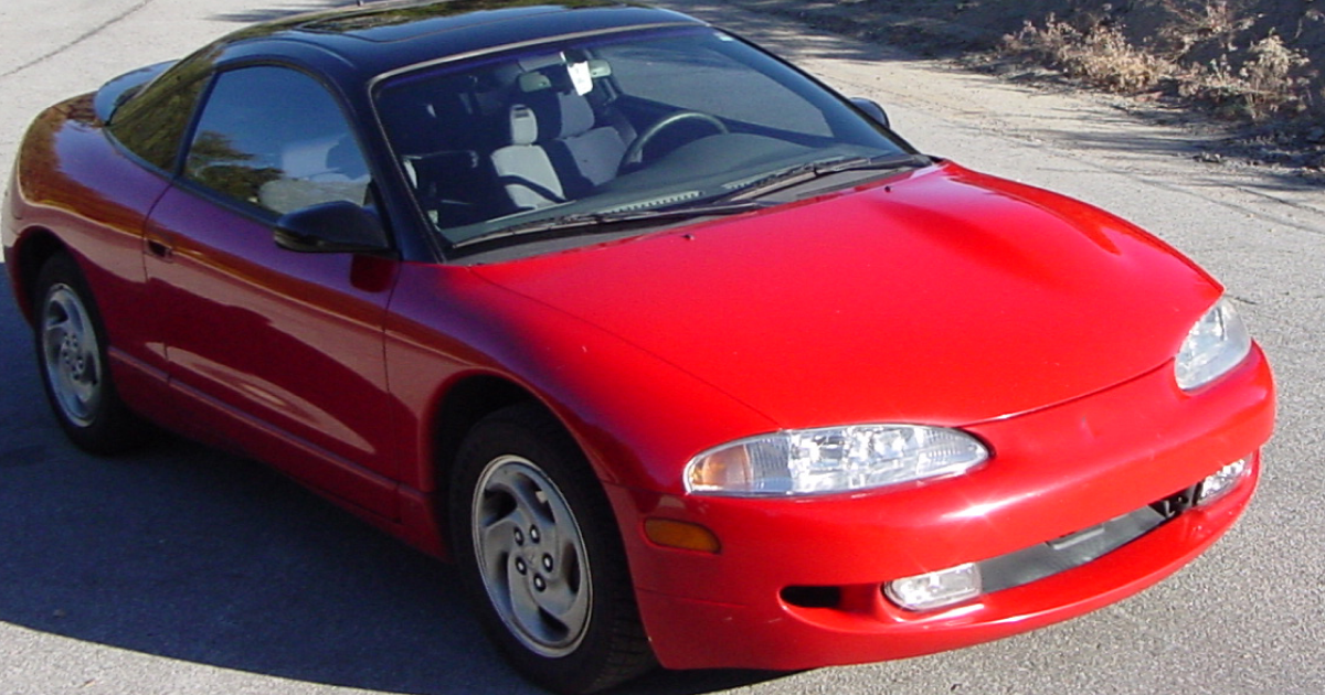 Red Mitsubishi Eclipse sports car with black roof.