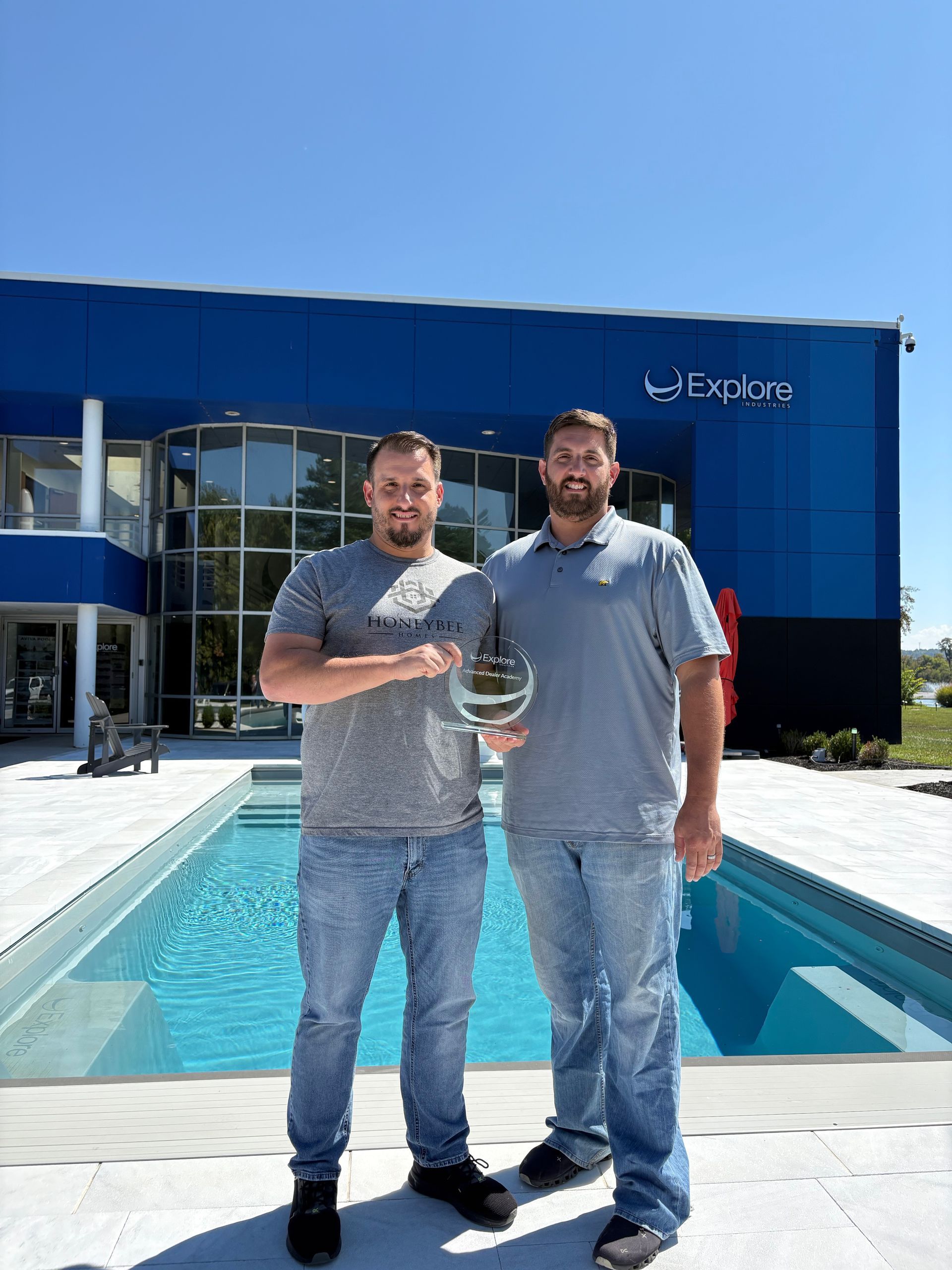 Small outdoor swimming pool with blue water and a metal handrail.