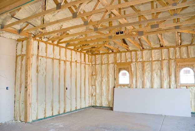 A room with a lot of spray foam insulation on the walls and ceiling.