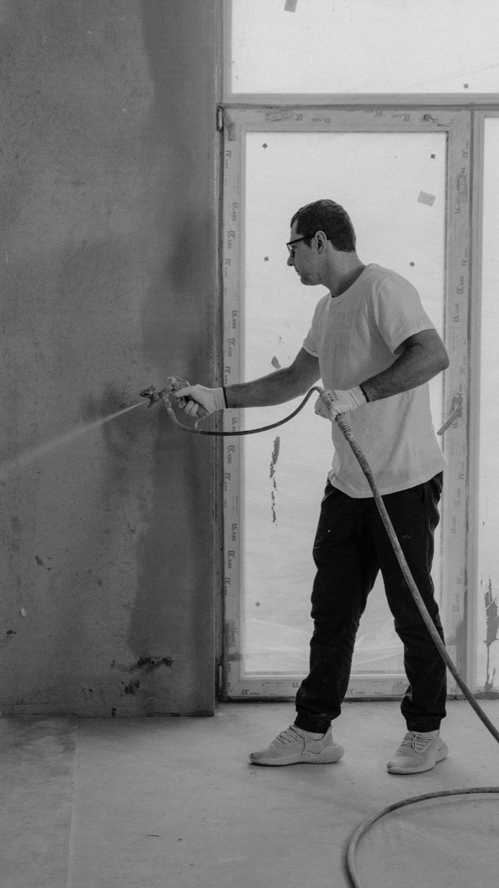 Professional spray foam insulation contractor applying insulation in a residential property.