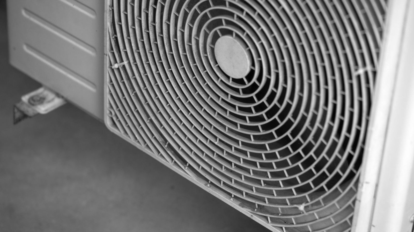 A black and white photo of a air source heat pump.