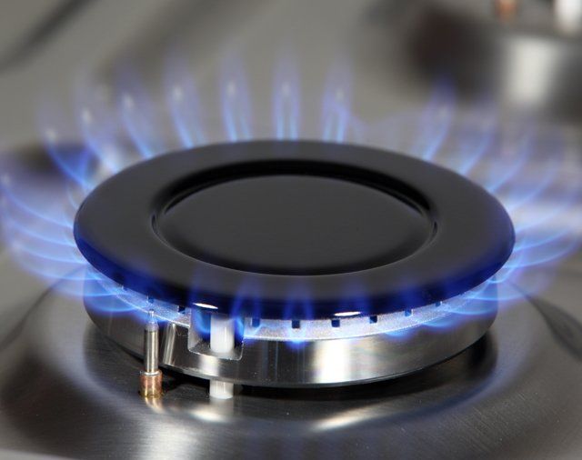 A close up of a gas burner with blue flames