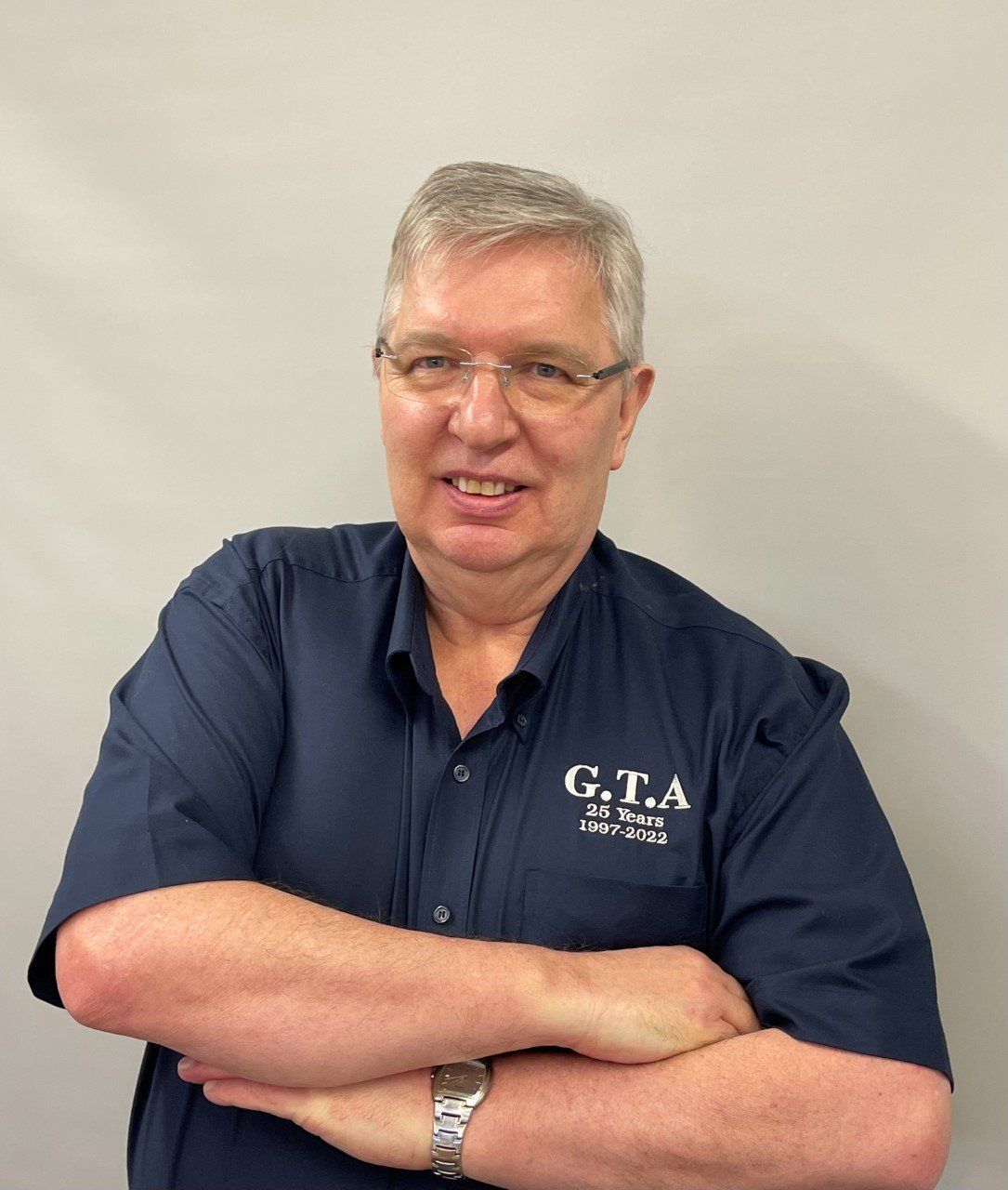 A man wearing a blue shirt that says g.t.a on it