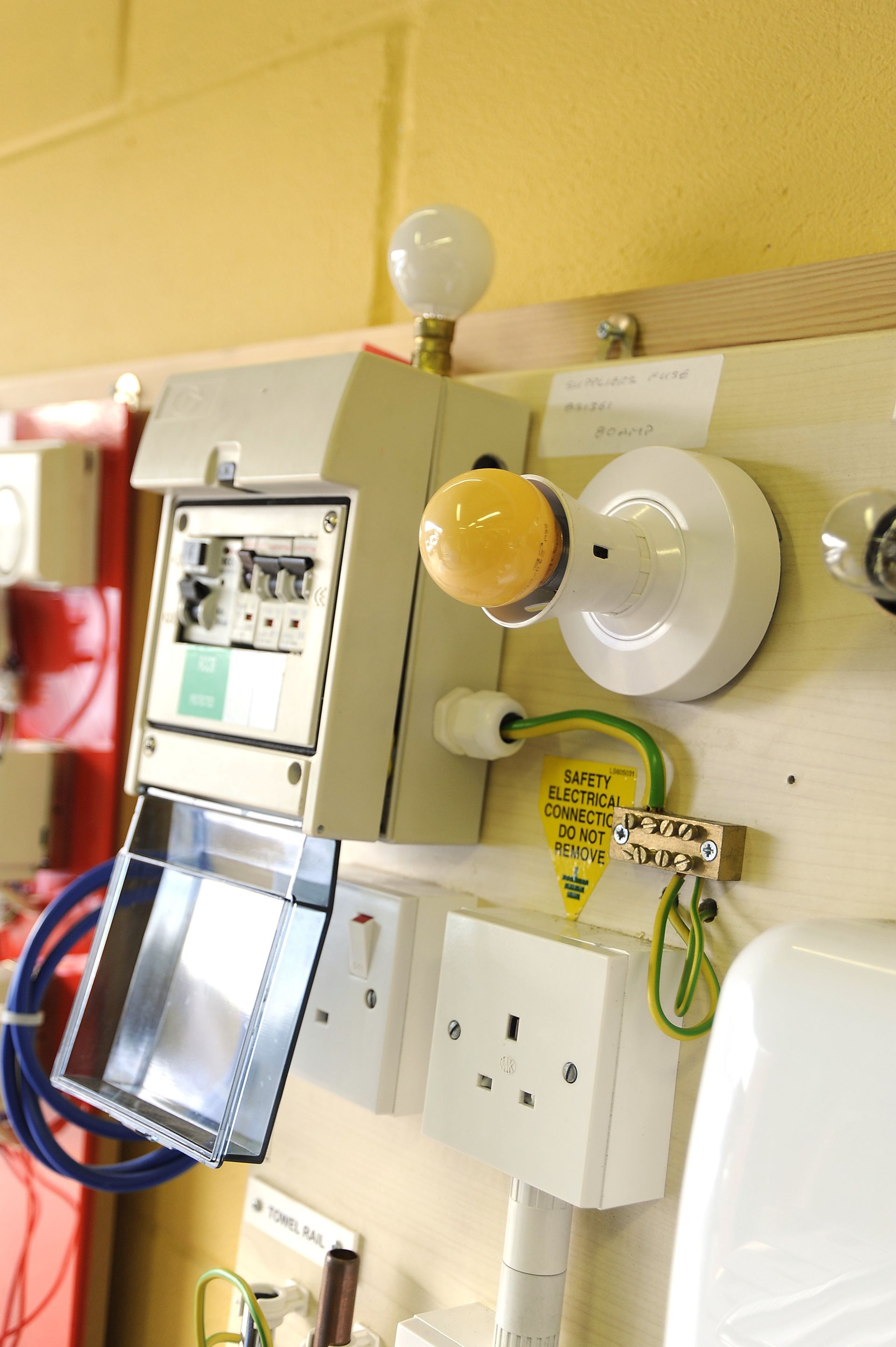 A wall with a bunch of electrical equipment on it