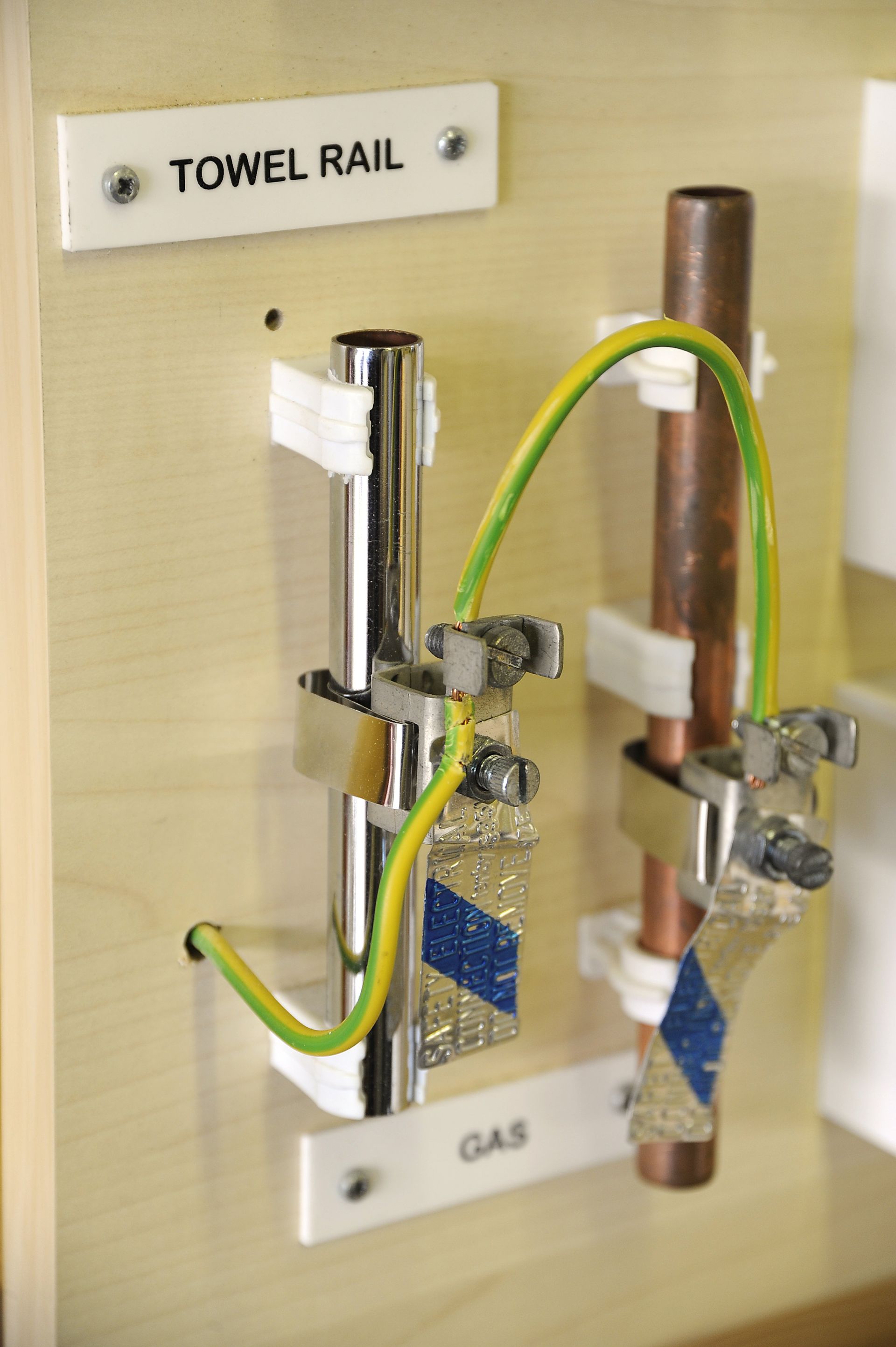 A towel rail is attached to a copper pipe