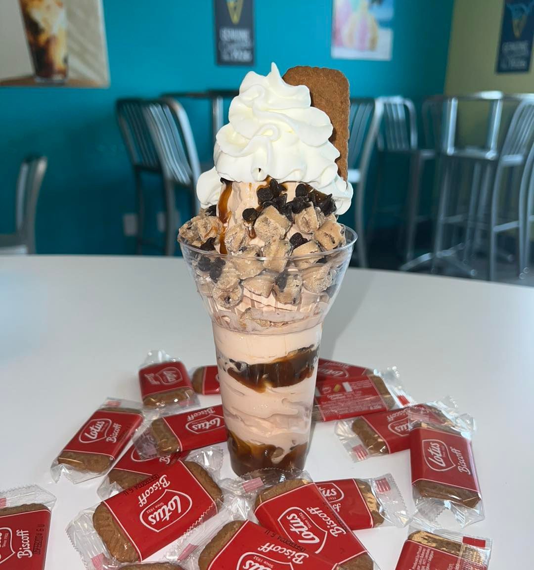 Come try our new Cookie Butter Parfait! Cookie butter custard layered with caramel, cookie dough, and chocolate chips, topped with whipped cream and a biscoff cookie!