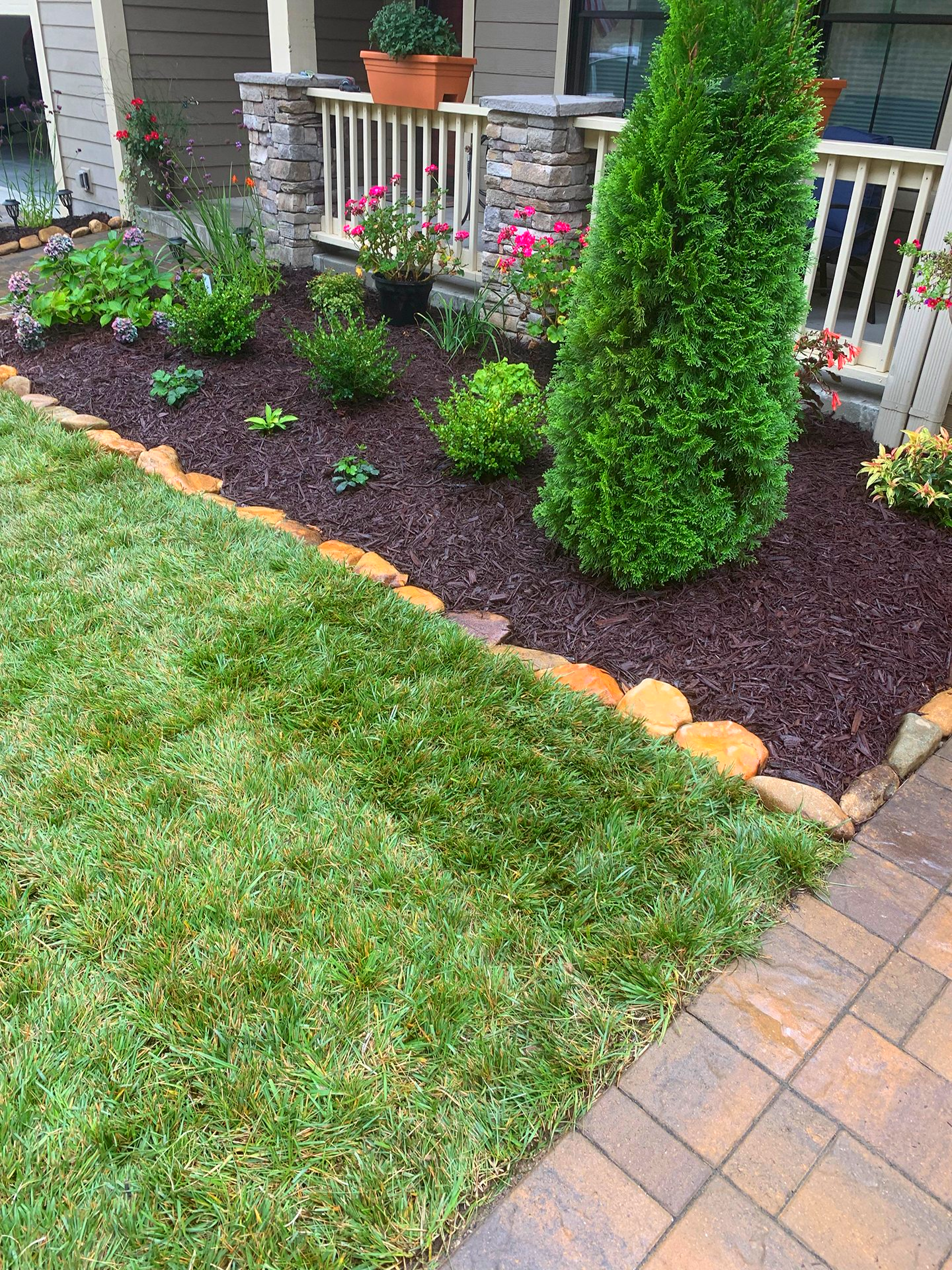 green lush lawn grass near landscaped planter