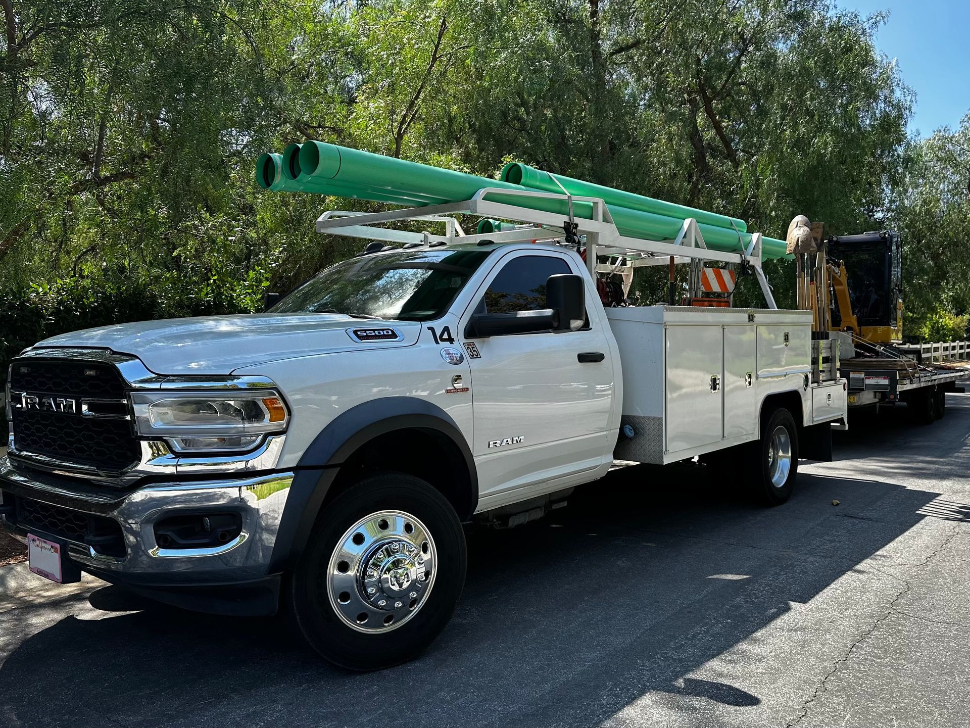 A White Truck With A Green Pipe On Top Of It Is Parked On The Side Of The Road — Granada Hills, CA  — Future Plumbing