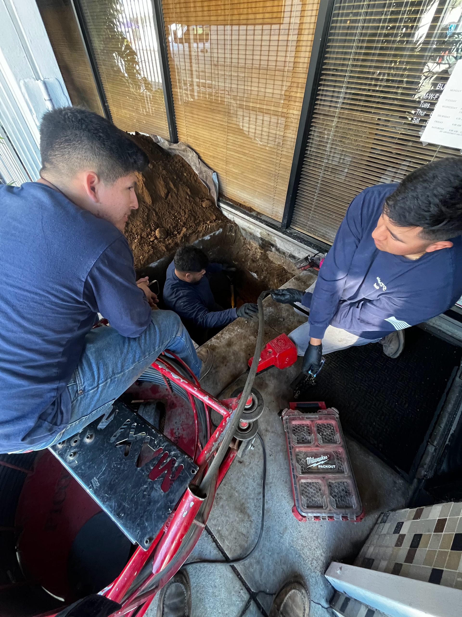 A Group of Men Are Working On a Drain in a Building — Granada Hills, CA  — Future Plumbing