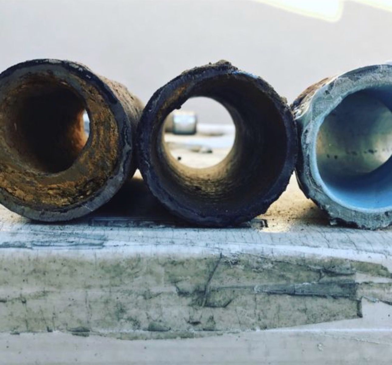 Three Pipes With Holes Lined up on a Table — Granada Hills, CA  — Future Plumbing