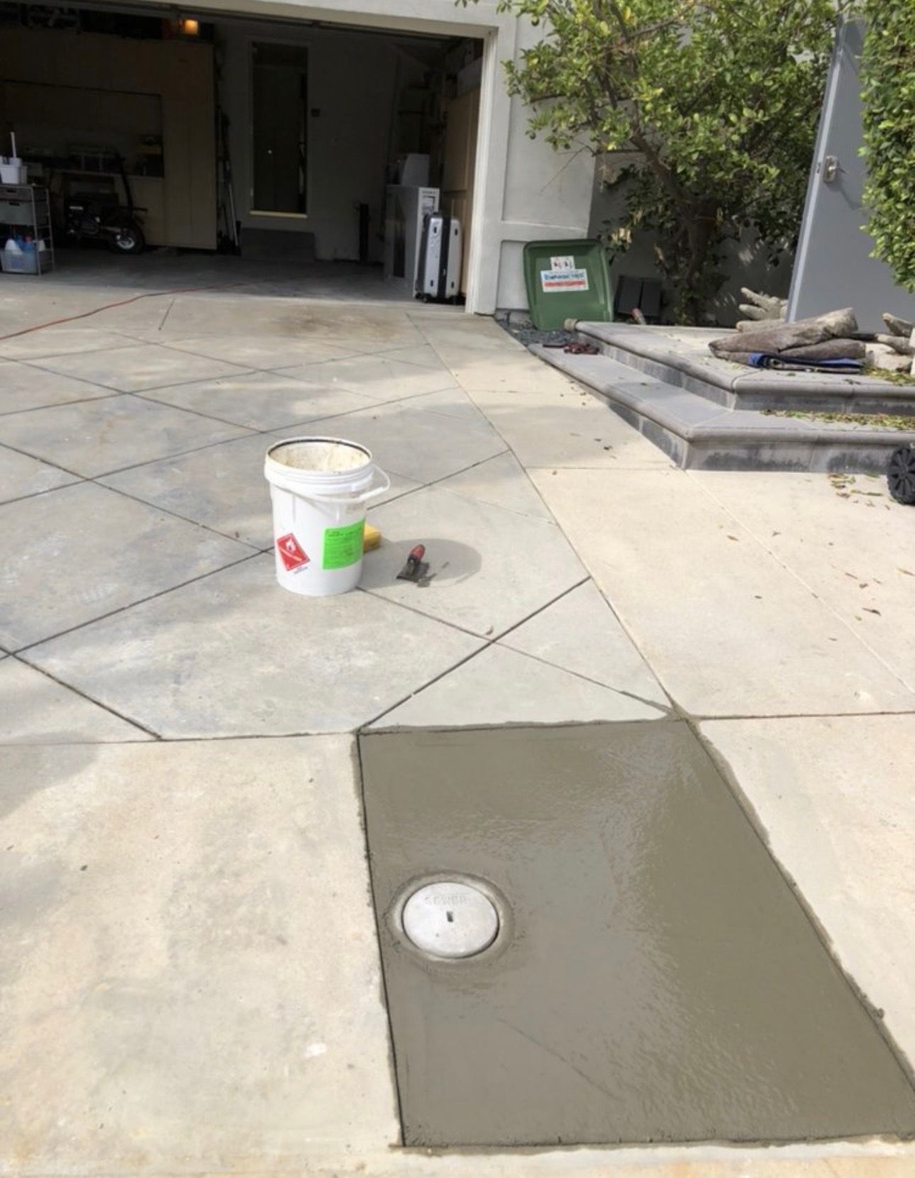 A Bucket of Concrete in Front of a Garage — Granada Hills, CA  — Future Plumbing