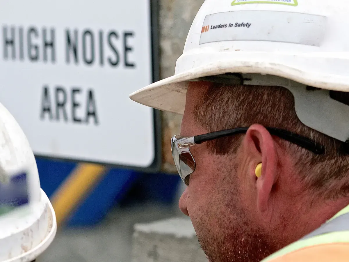 A construction worker wearing a hearing aid in his place of work.