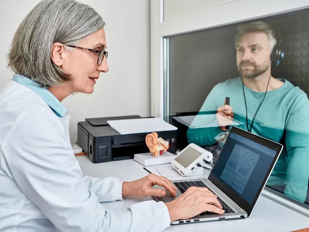 A person looking for hearing aid options with help of a hearing aid specialist.