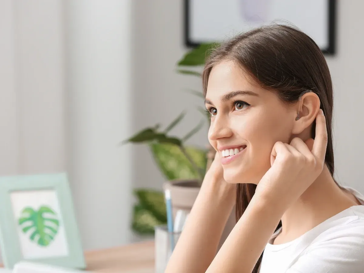 An image of a girl appreciating the sound quality of having a hearing aid in different environments.