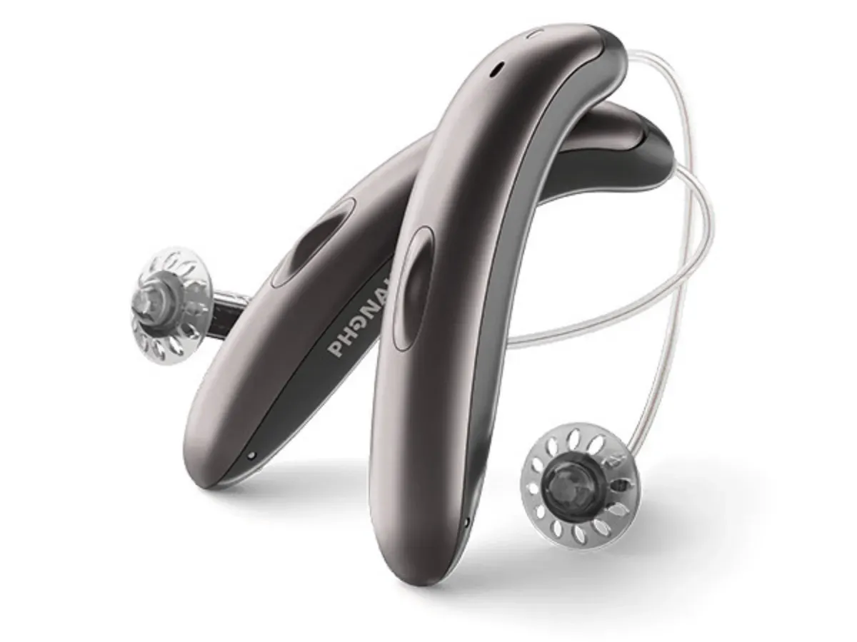 Image showing rechargeable hearing aid with charging case, emphasizing battery life and quick-charging capabilities.
