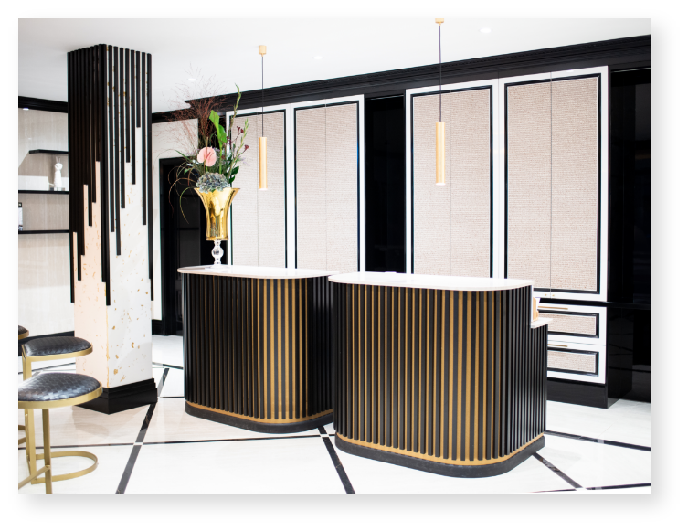 A room with two reception desks and a vase of flowers.