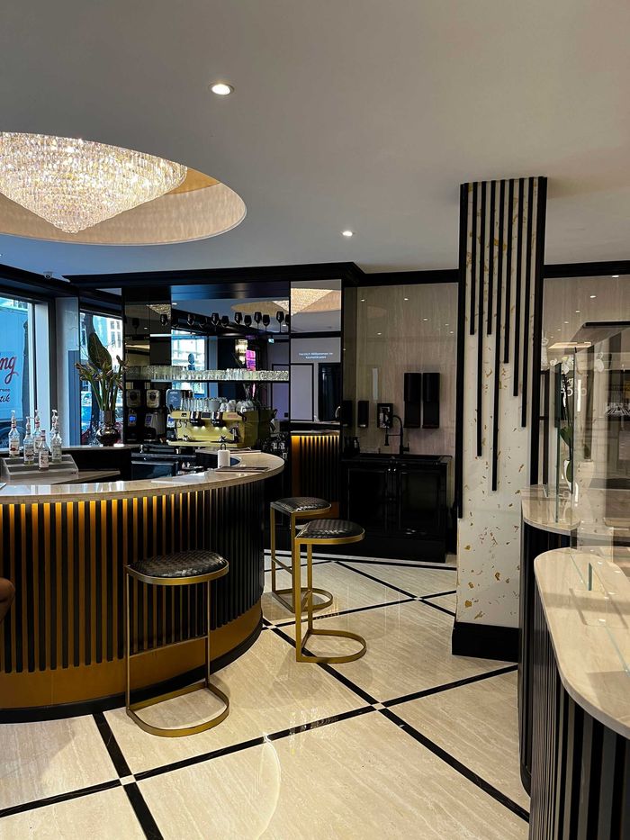 A large room with a bar and stools in it