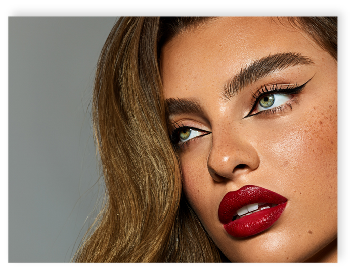 A close up of a woman 's face with red lipstick and eyeliner.
