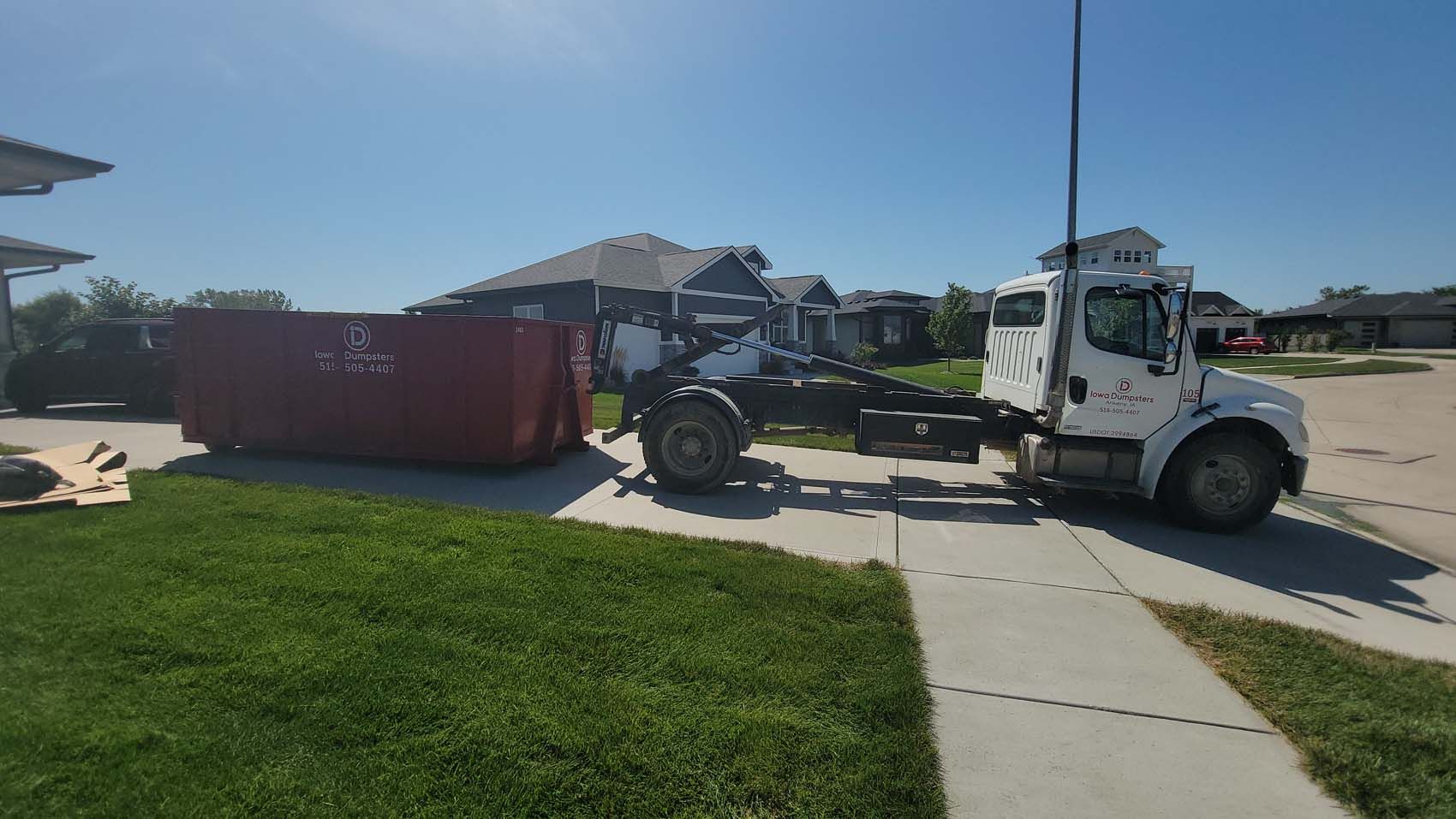 Trailer truck pulling a dumpster can