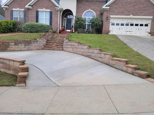 Brick house with arched doorway, tall windows, and a two-car garage.