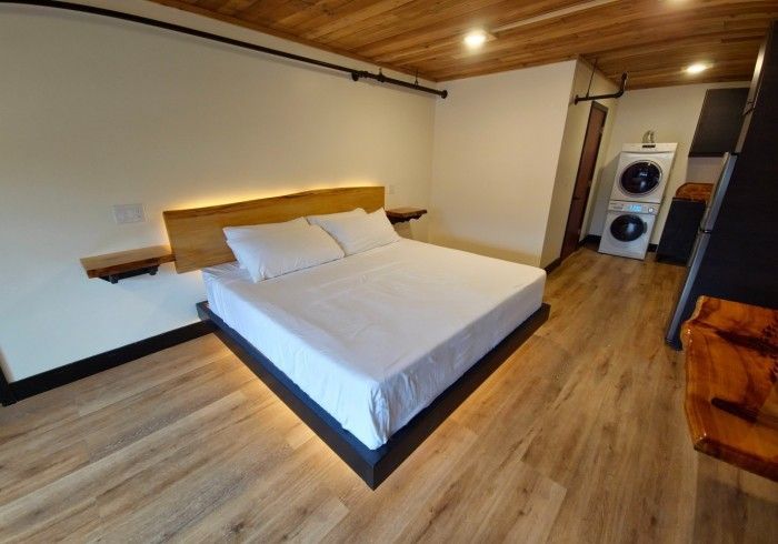 A bedroom with a king size bed and a washer and dryer