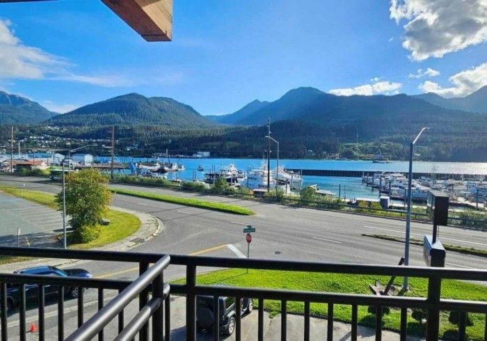 A balcony overlooking a body of water with mountains in the background