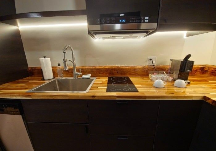 A kitchen with a sink and stove top oven