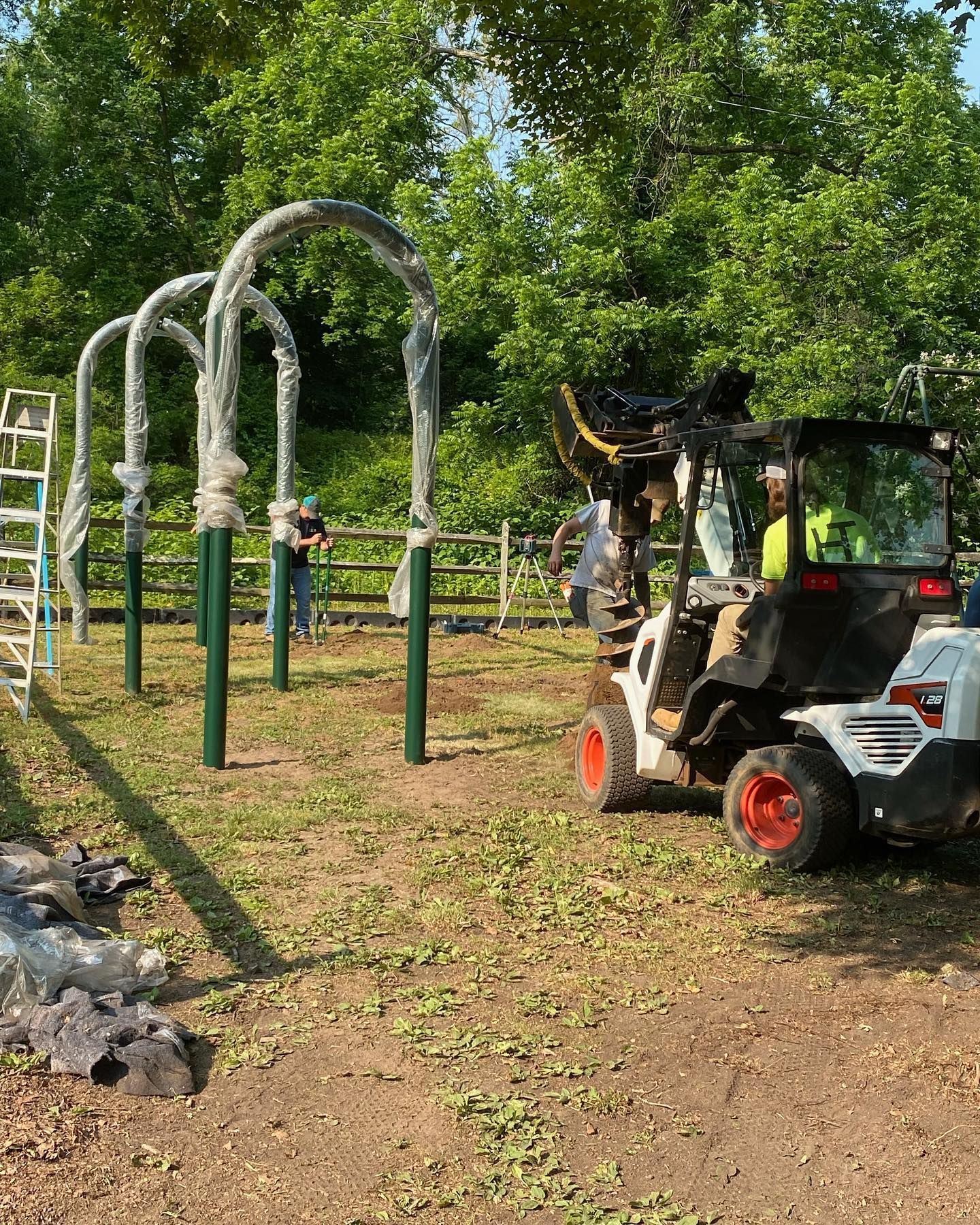 A man is driving a forklift in a park.