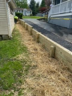 A wooden fence is being built in front of a house.