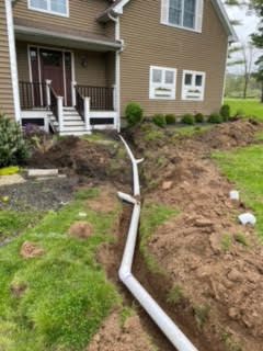 A house with a drain pipe in front of it.
