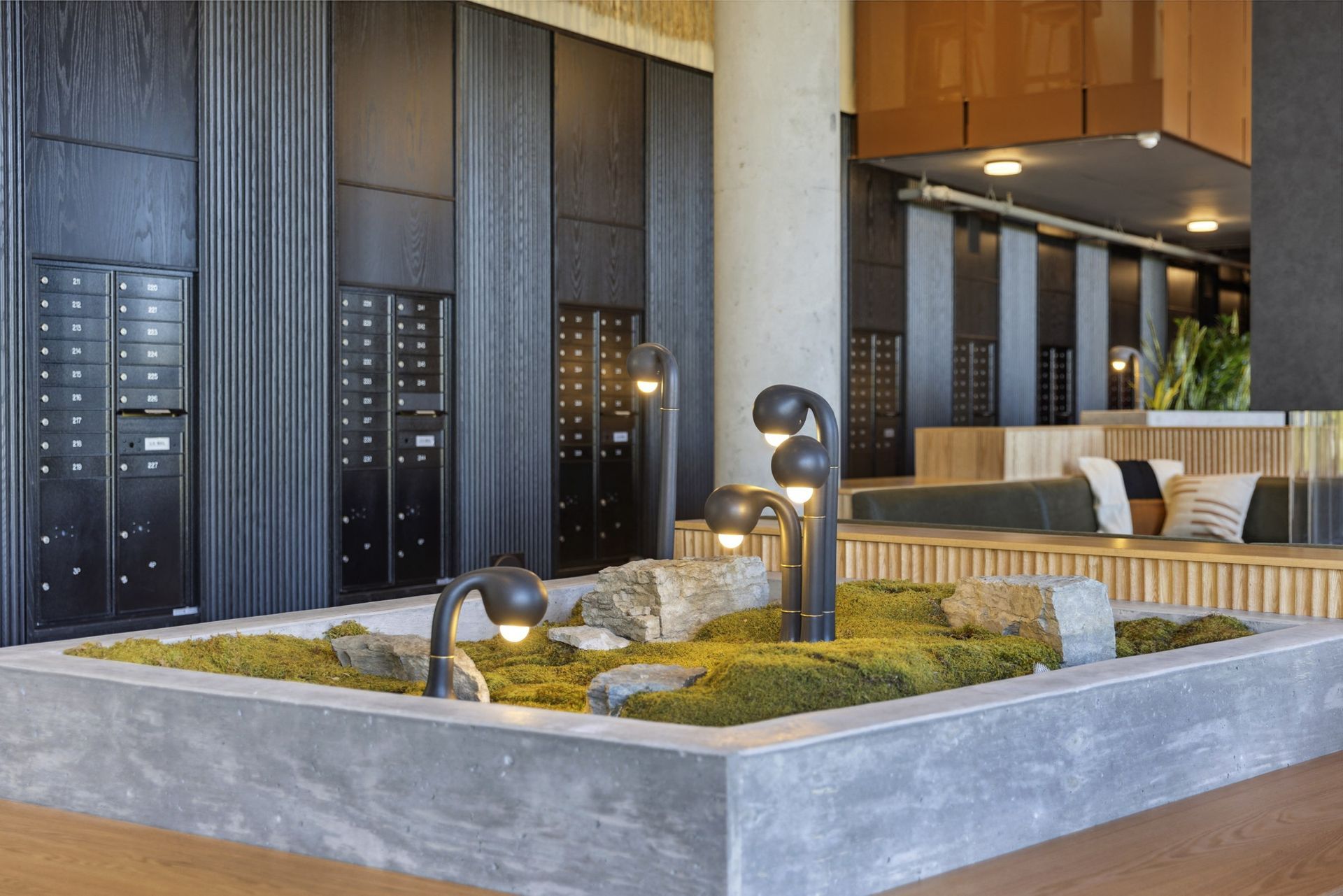 Modern apartment lobby with mailboxes along the wall and a seating area at Esox House in St. Paul, MN.