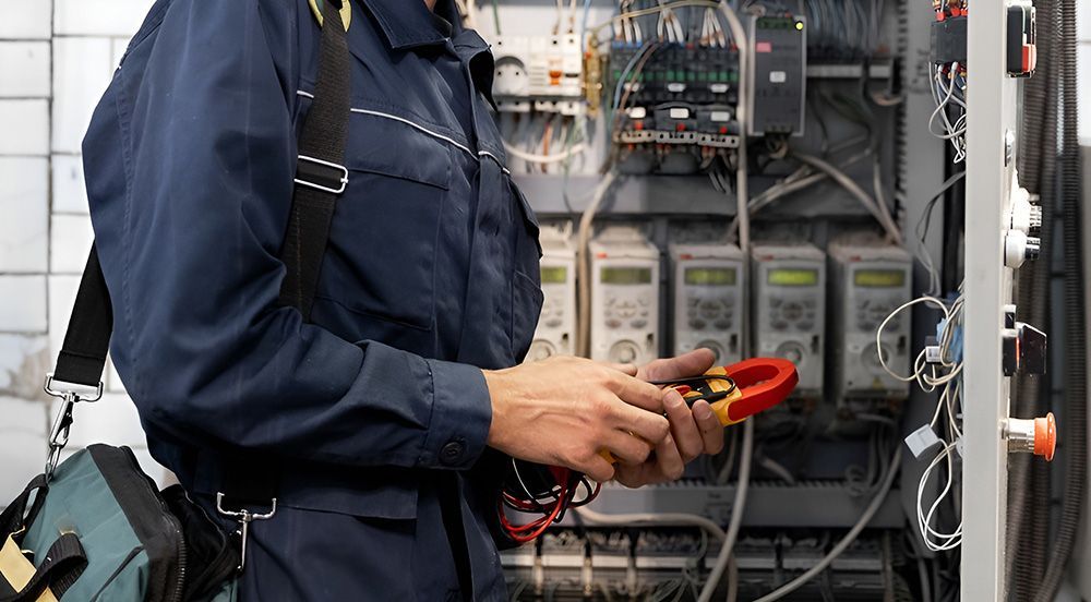Electrician Using a Clamp Meter on Electrical Panel