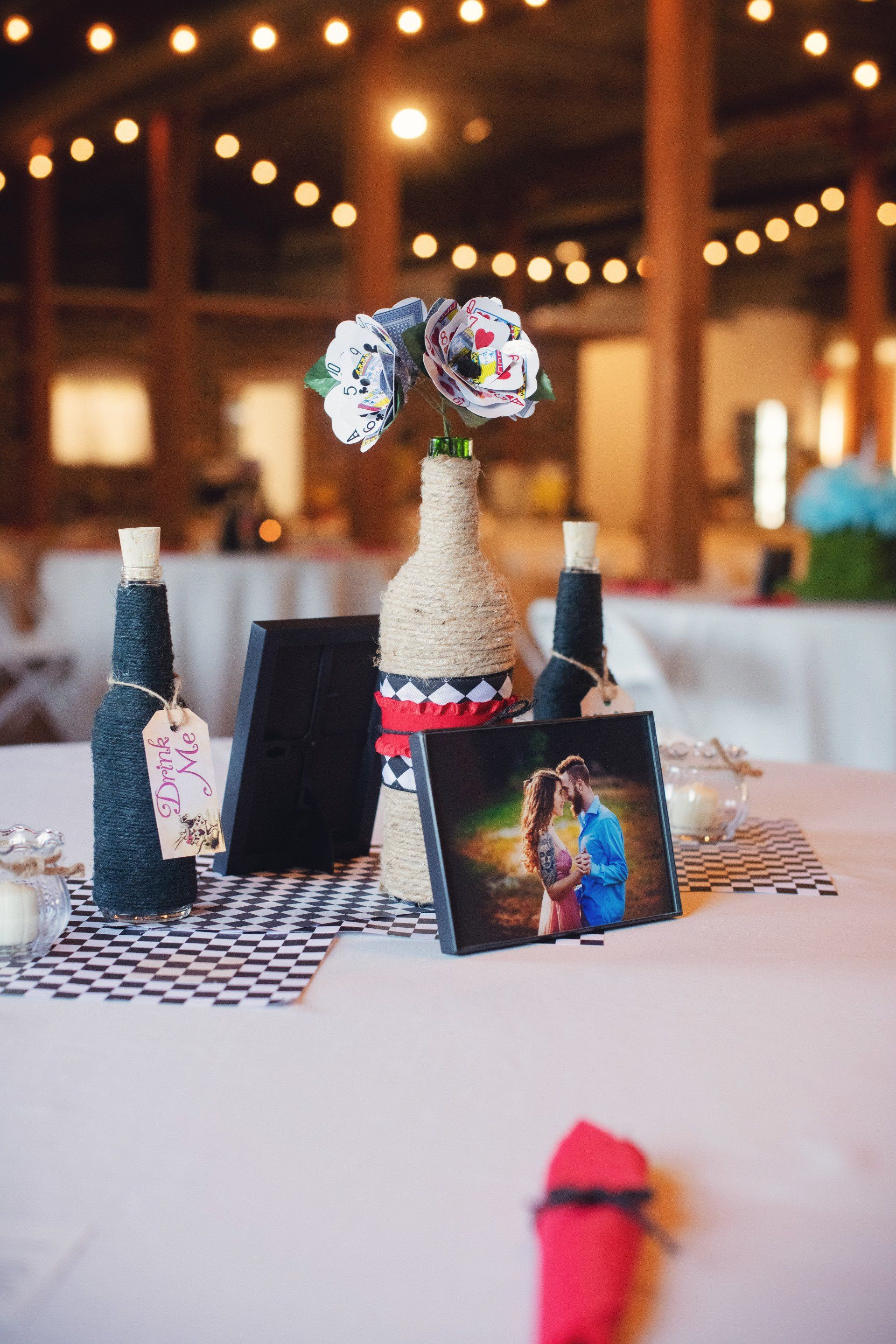 A table with a vase of flowers and a picture on it