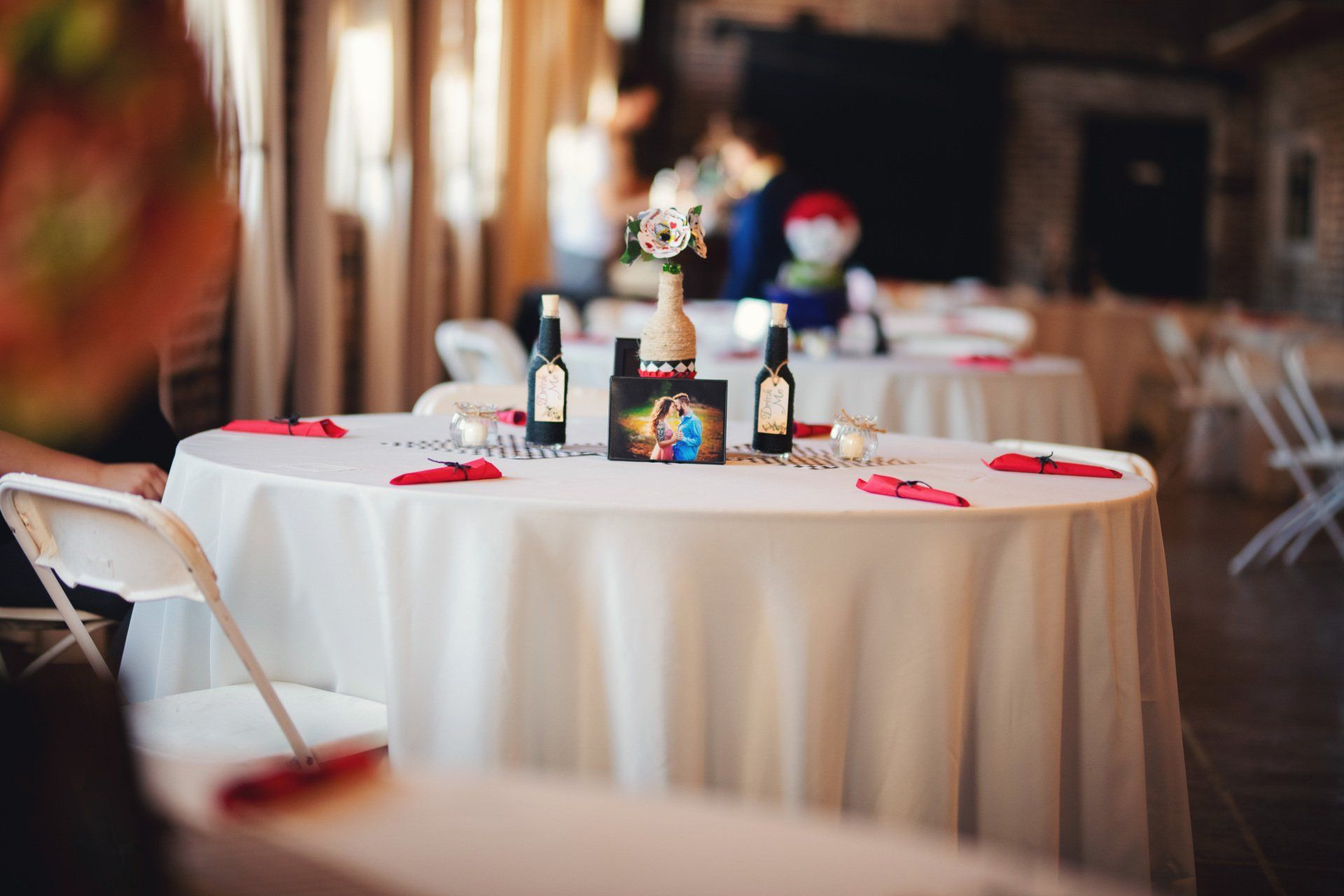 A table set up for a wedding reception with a picture of a couple on it.