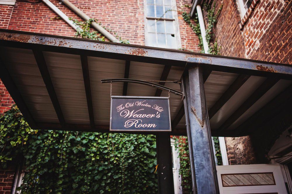 A sign hangs from the roof of a building that says heaven 's room