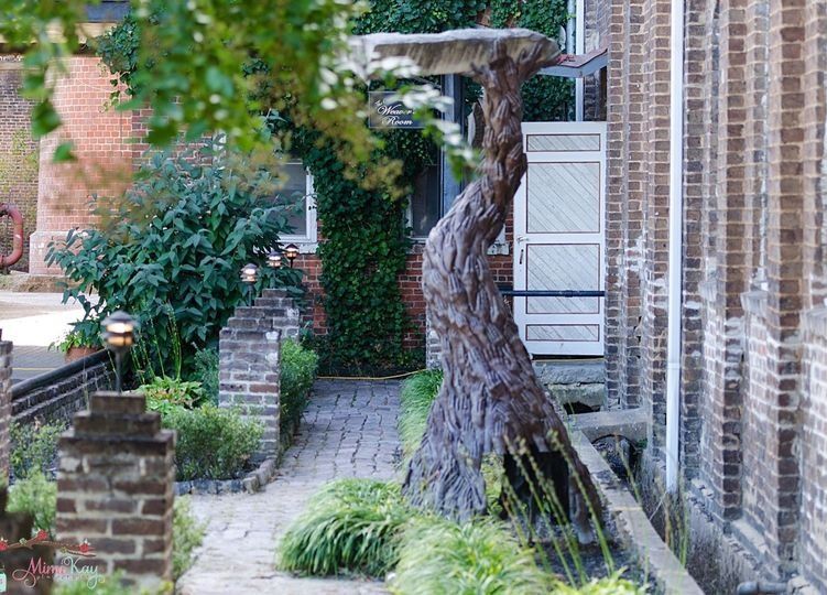 A brick building with a bird bath in front of it