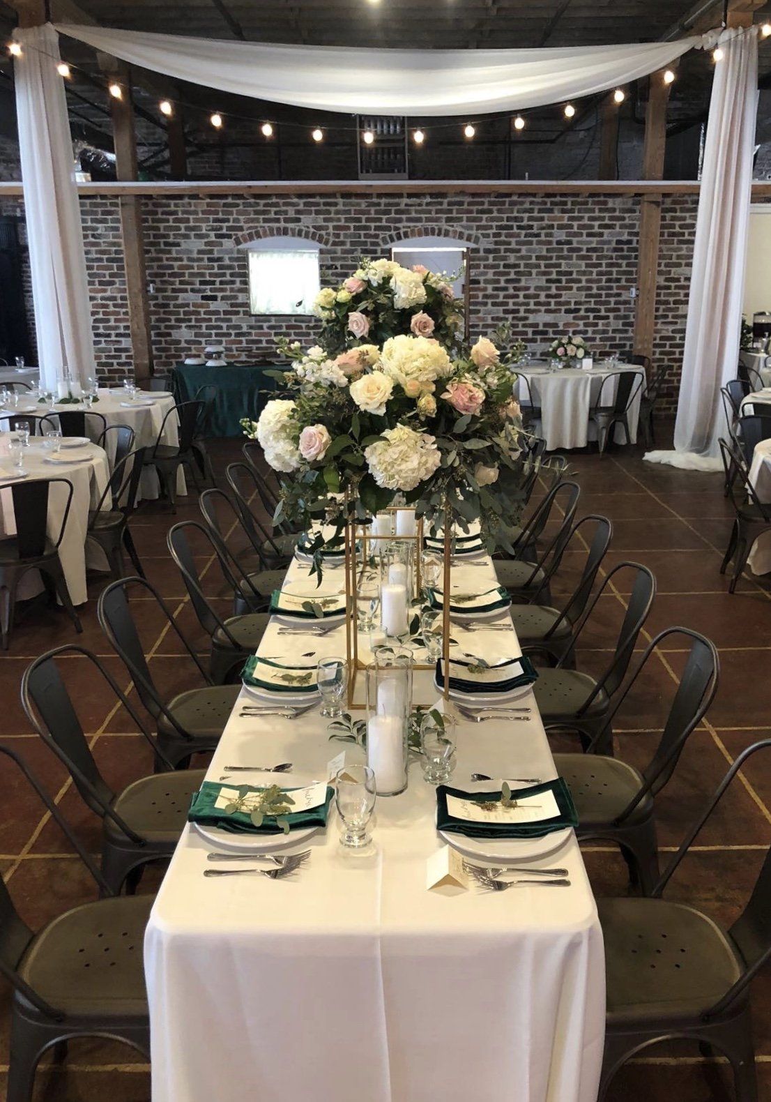 A long table with a vase of flowers on top of it.