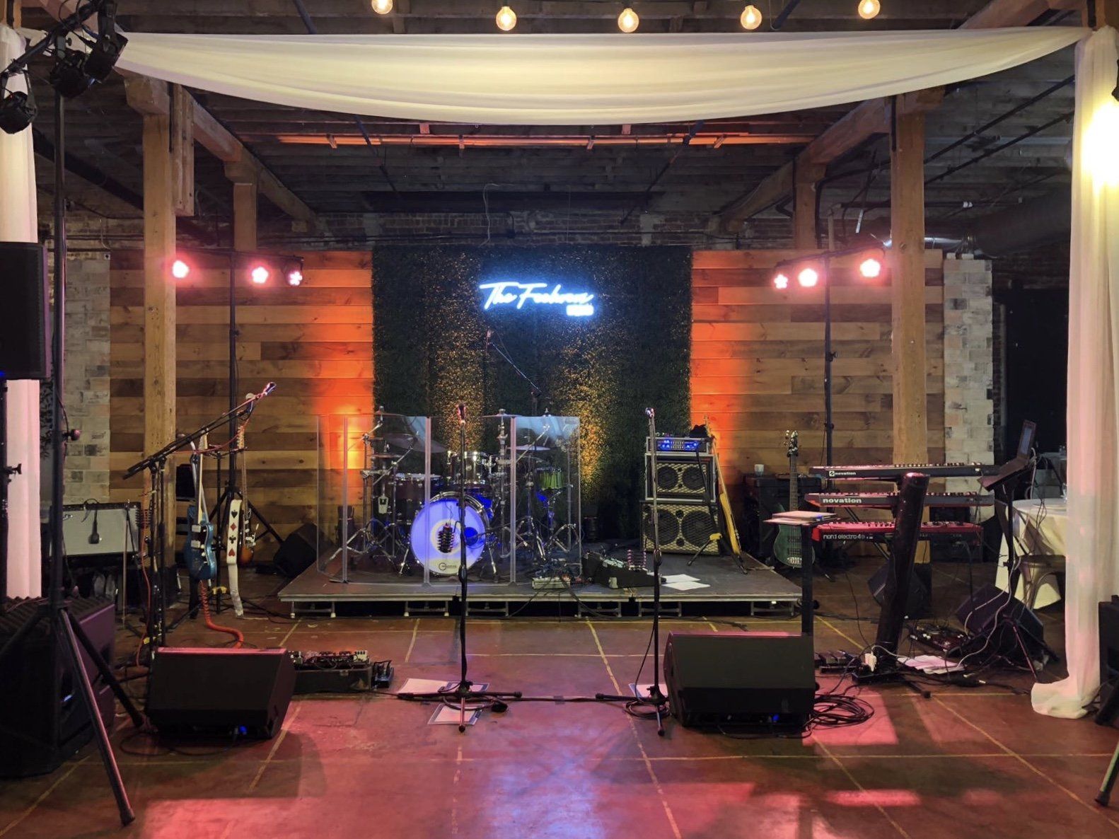 A large room with a stage and a lot of instruments on it.