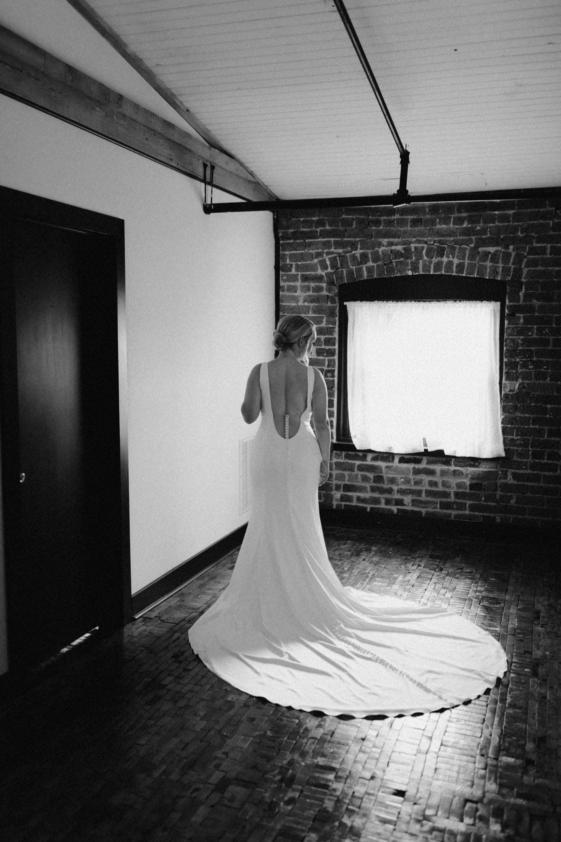 A black and white photo of a woman in a wedding dress