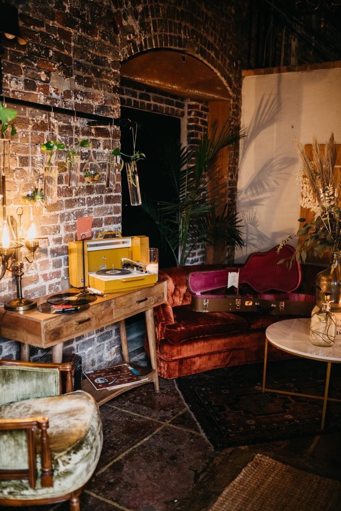 A living room filled with furniture and a brick wall.