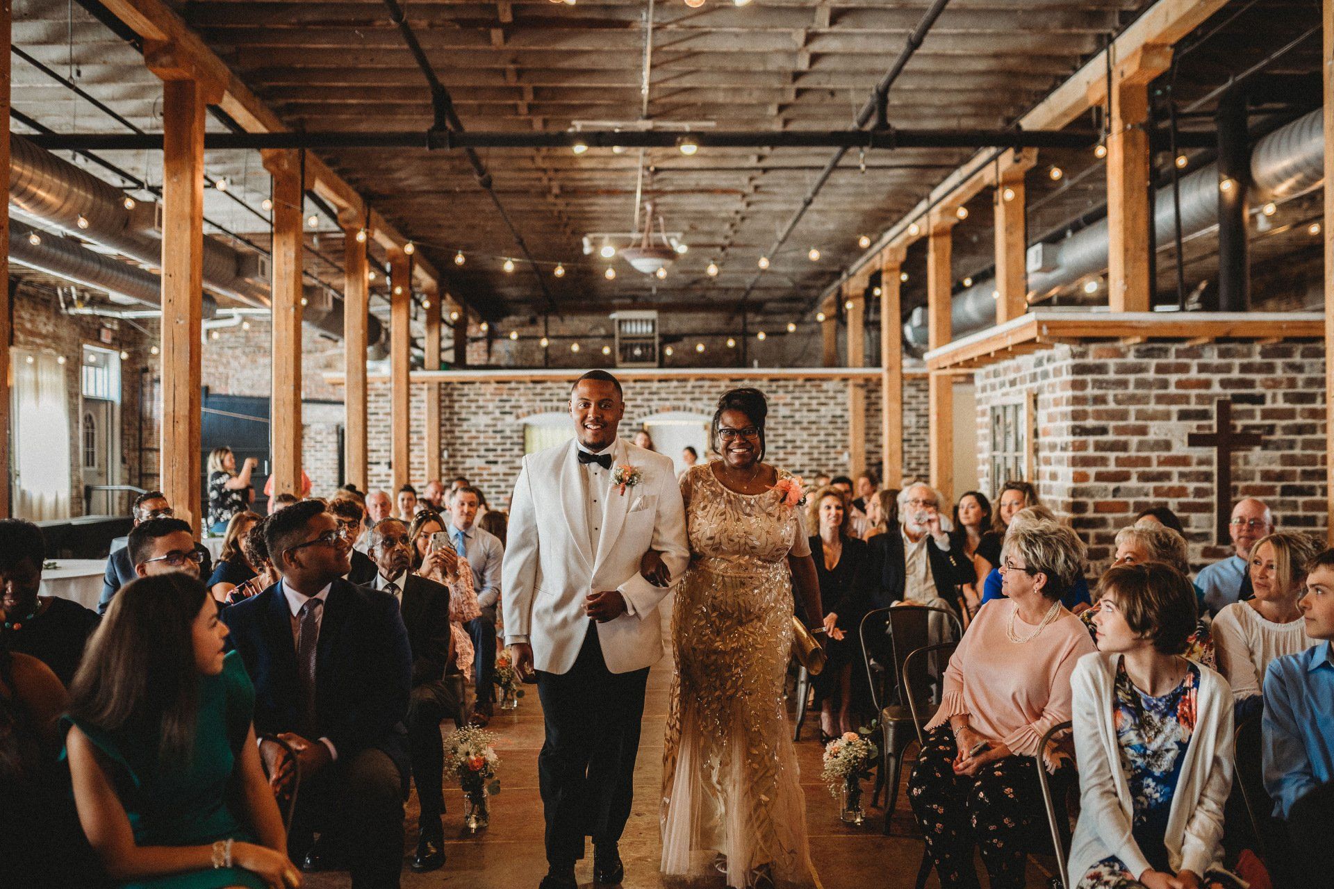 A bride and groom are walking down the aisle at a wedding ceremony.