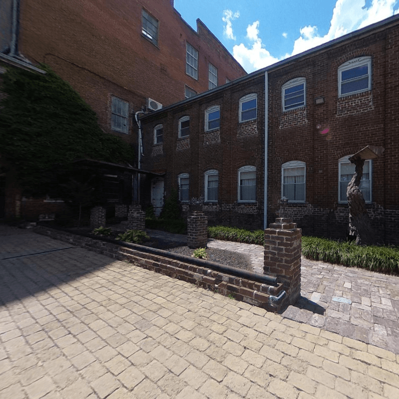 A brick building with a brick walkway in front of it