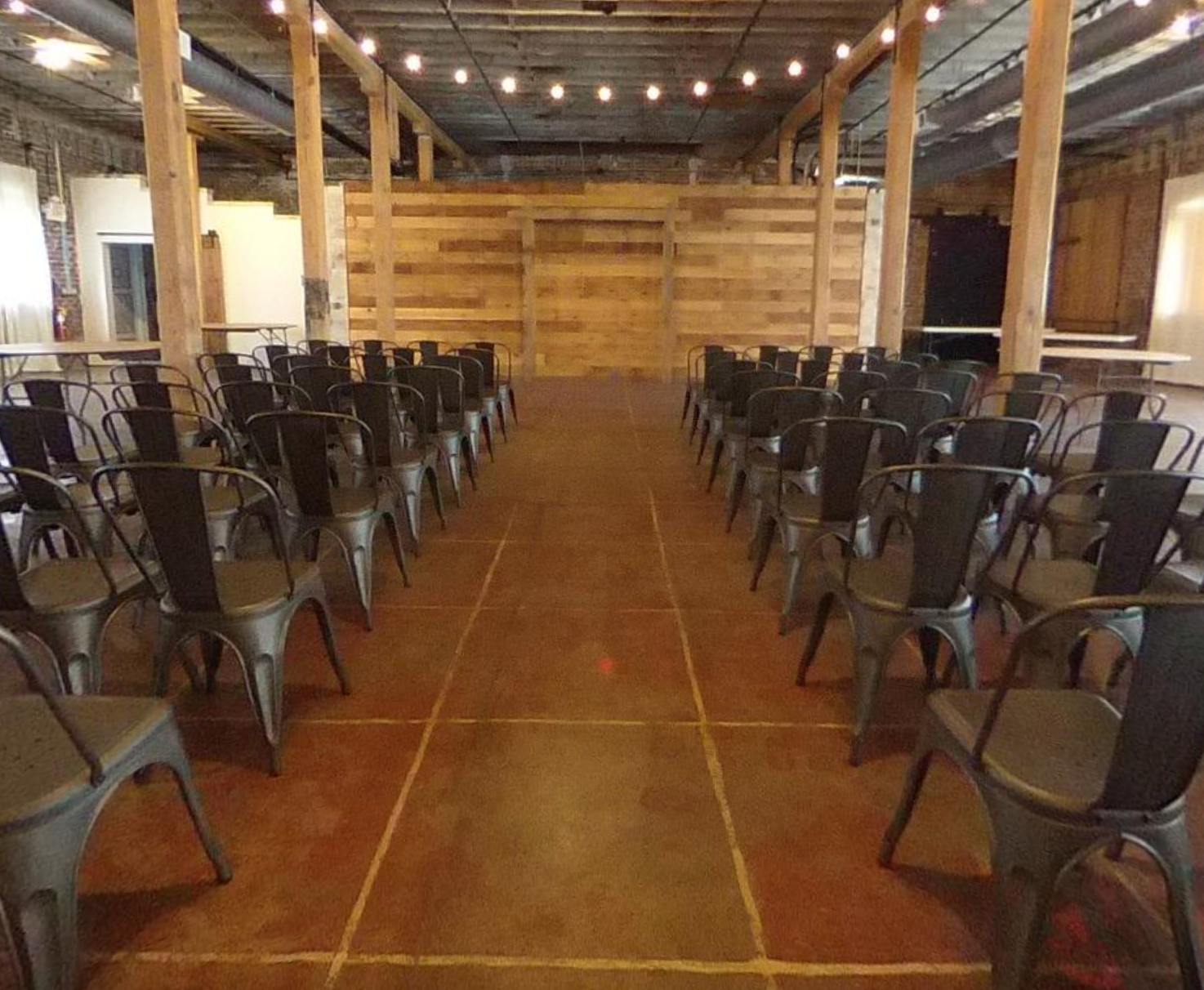 Rows of chairs are lined up in a large room.