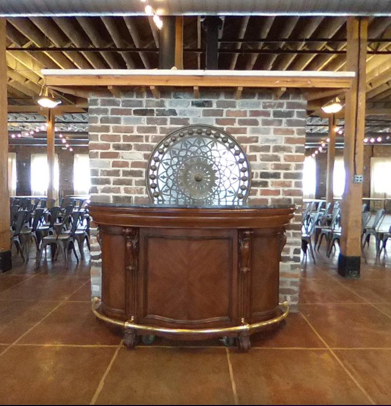 A brick wall with a wooden bar in front of it