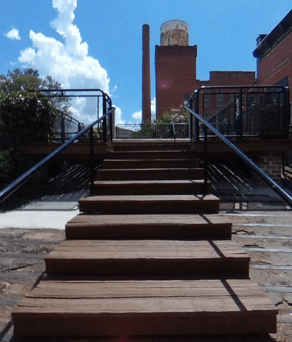 A set of wooden stairs leading up to a brick building