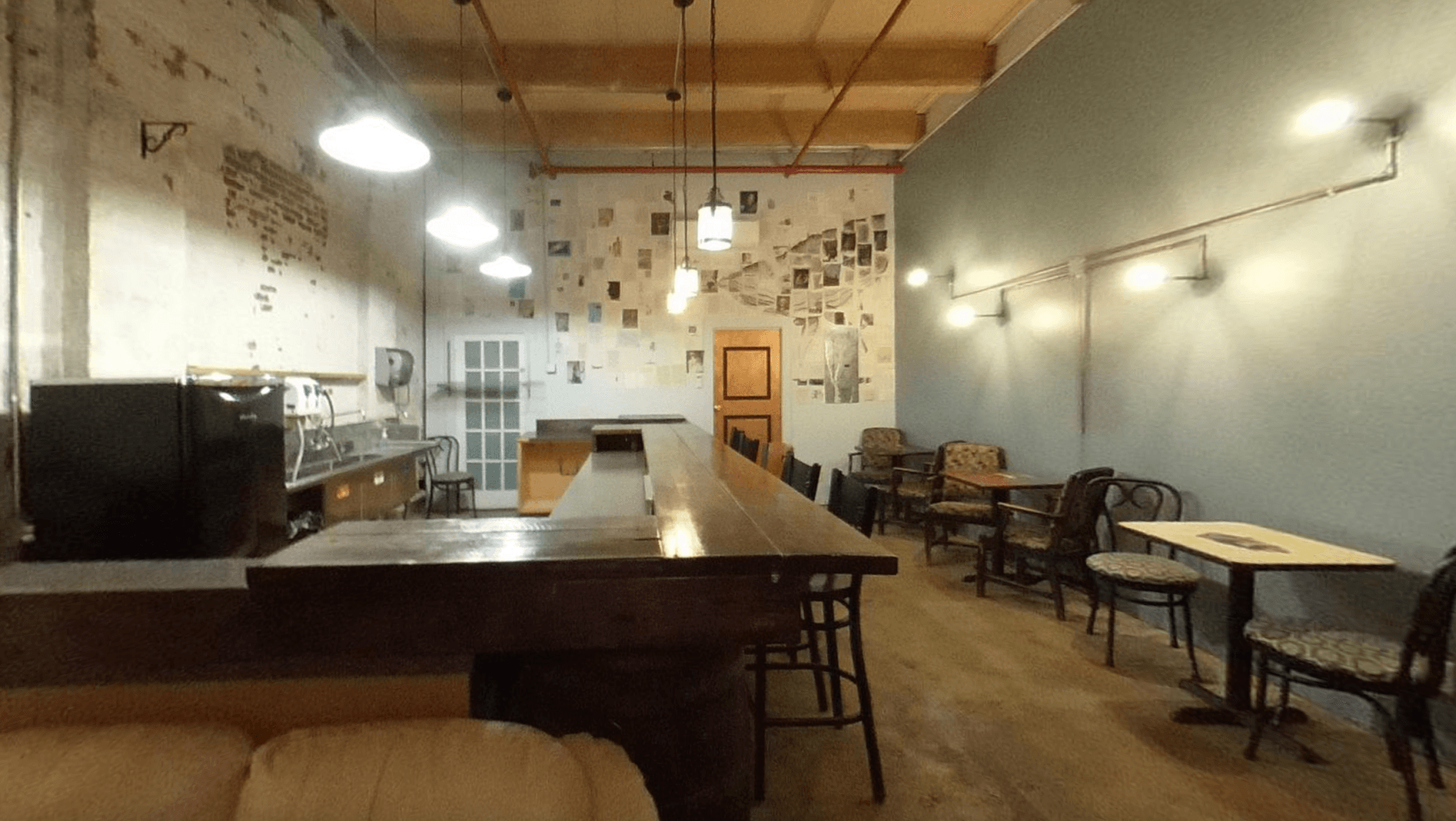 A restaurant with tables and chairs and a long counter