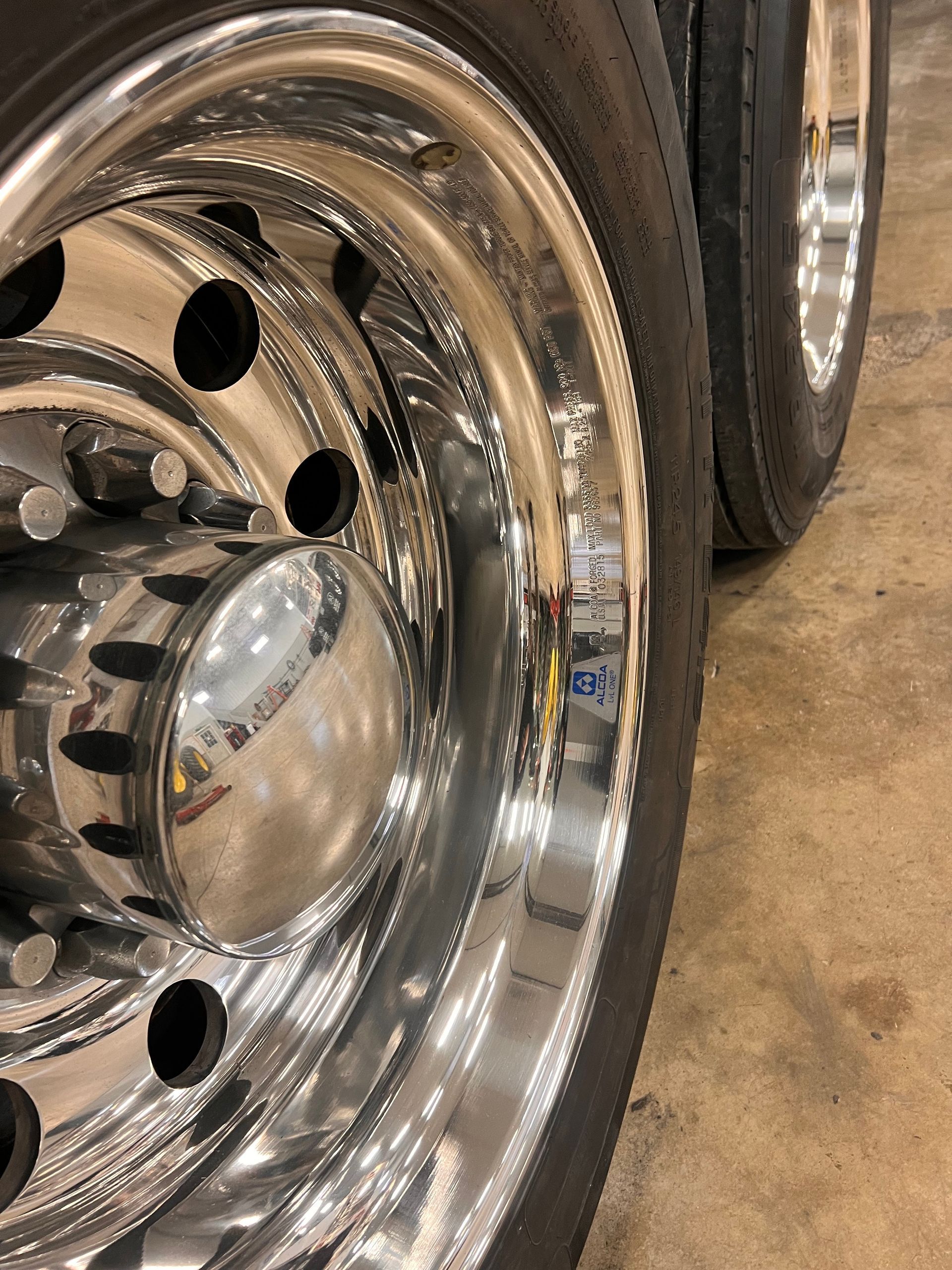 A close up of a chrome wheel on a truck