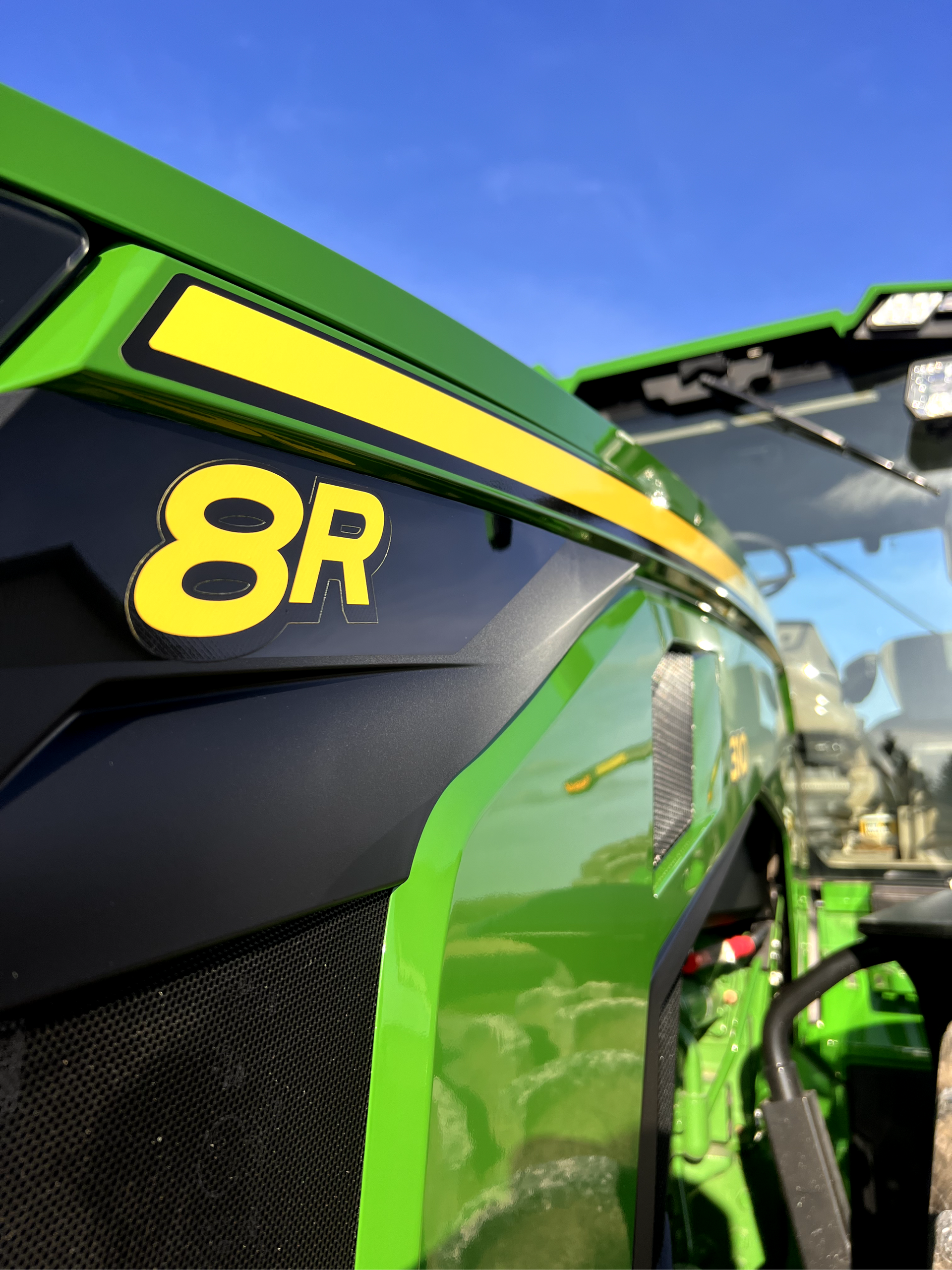 A green tractor with the number 8r on the side