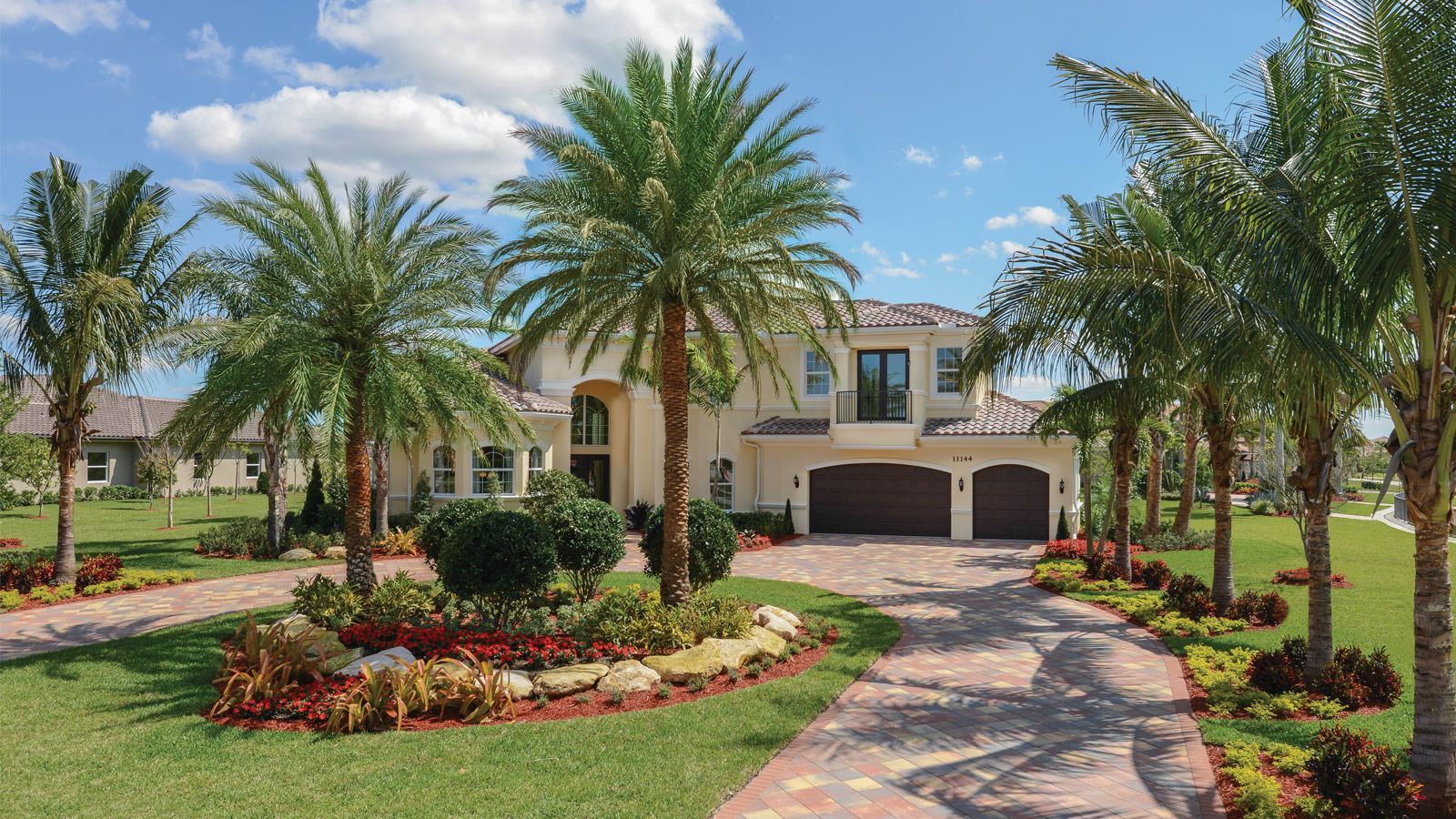 A large house with palm trees in front of it