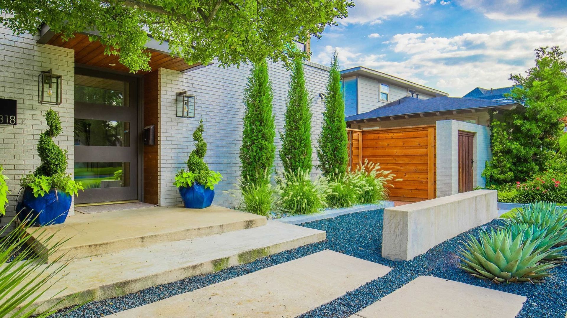 The front of a house with a walkway leading to it.